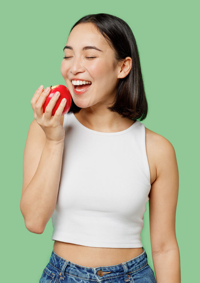 Woman biting into an apple