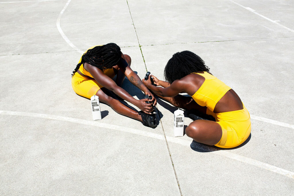 two women doing post workout recovery